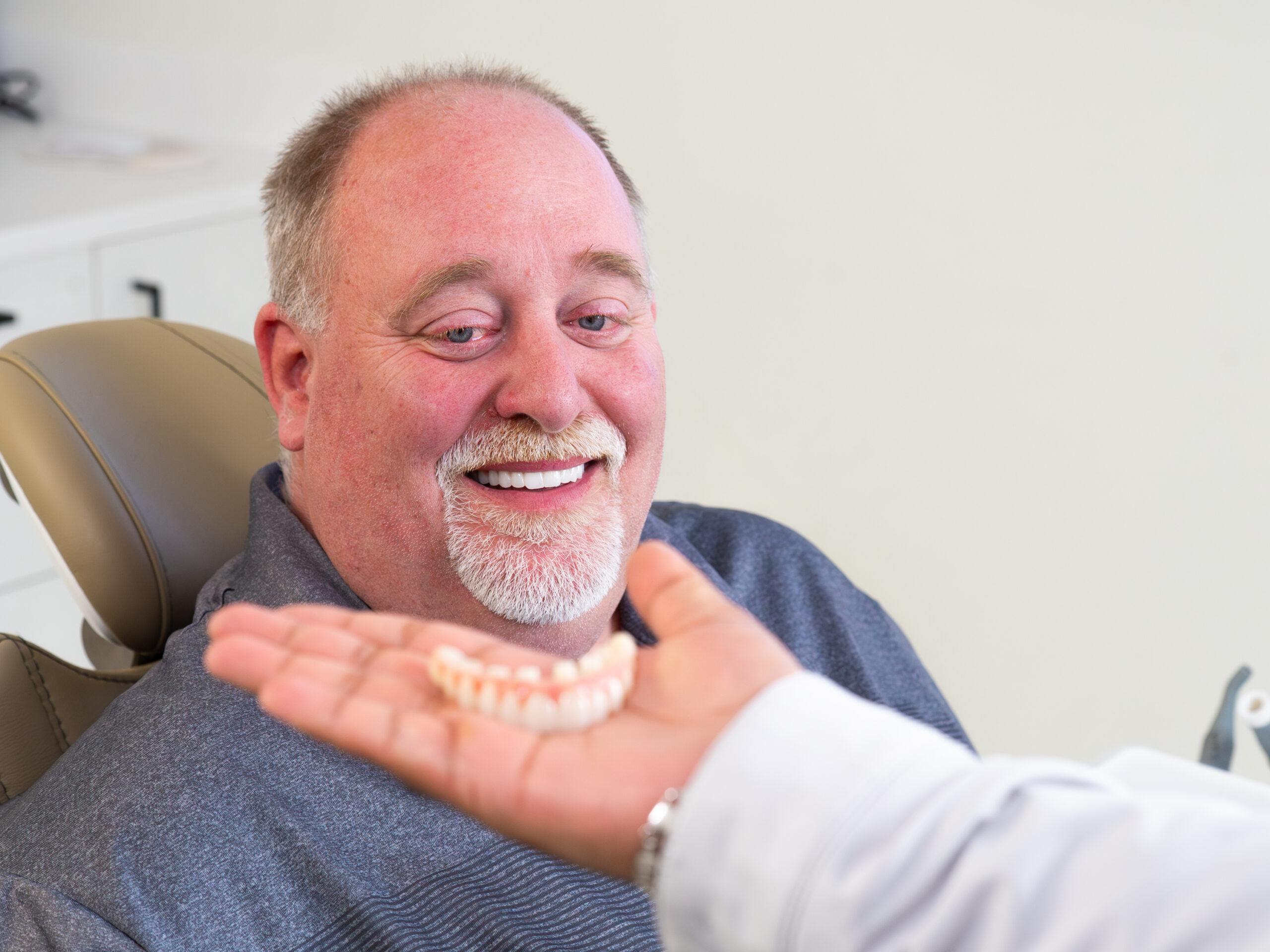 Happy dental implant patient at Luminous Dentistry Wakefield MA
